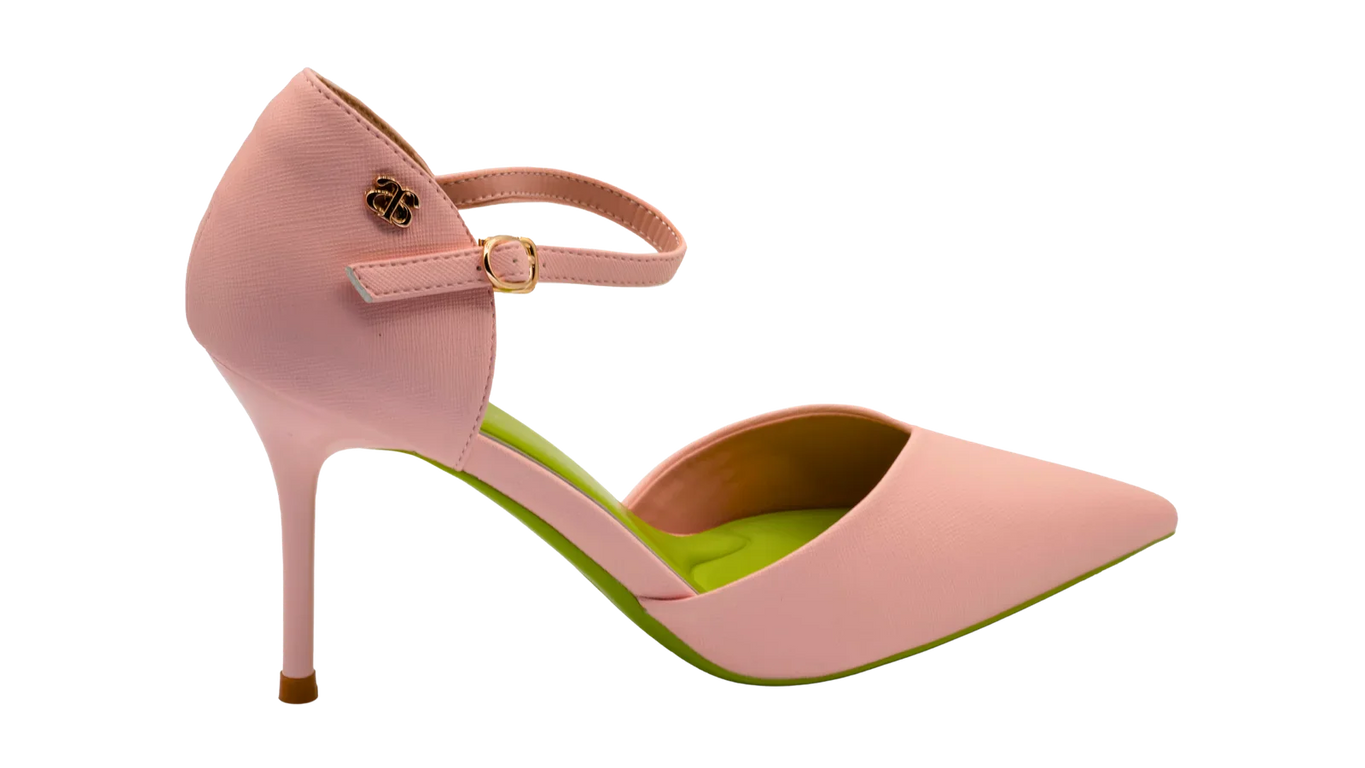 A close-up of avarerarth's stylish pink heels, featuring a delicate ankle strap and a bold green sole. These sustainable and eco-conscious avarshoes are a perfect blend of fashion and responsibility. These are eco glow heels.